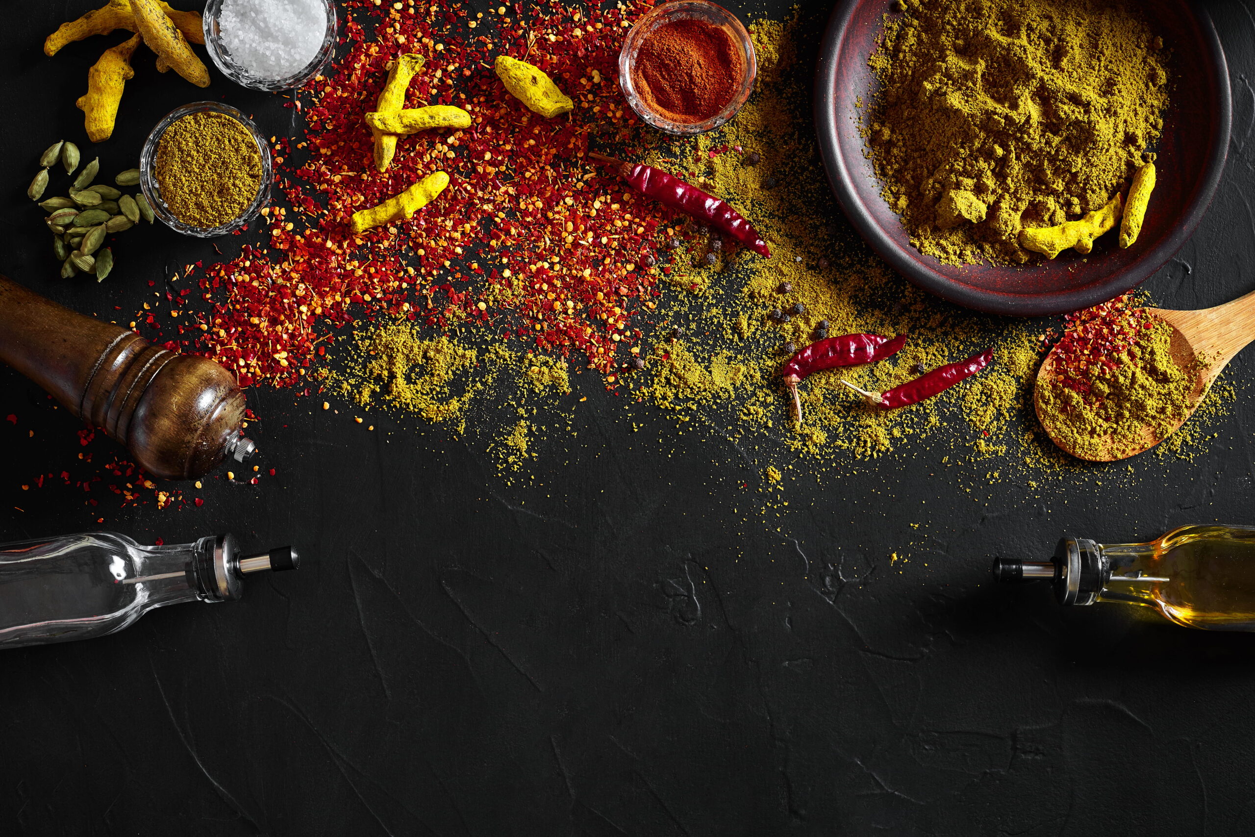 cooking using fresh ground spices with big small bowls spice black table with powder spillage its surface overhead view with copyspace still life flat lay top view (1)